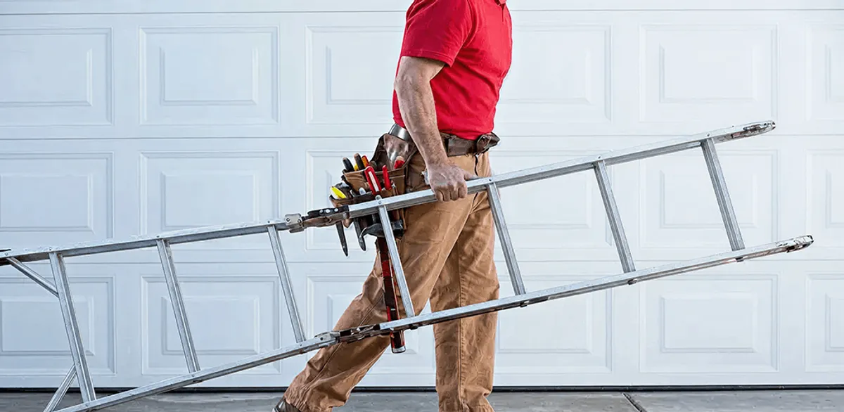 Garage door repair technician arriving with tools and ladder in Columbia, MO